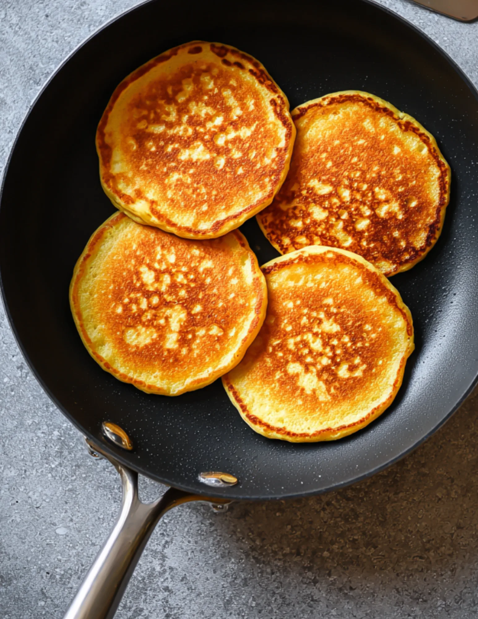Pumpkin protein pancakes in skillet